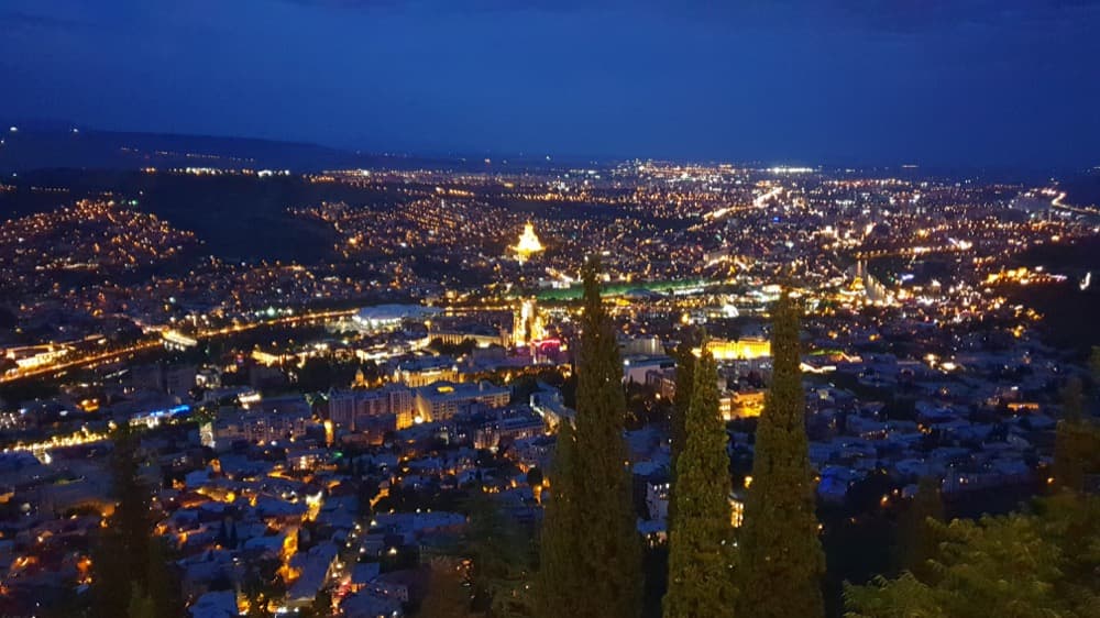 nighttime view of tbilisi city from a nearby hilltop